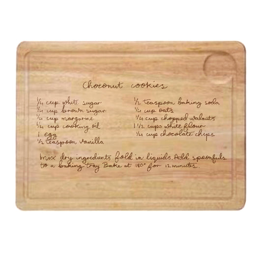 Wooden cutting board with engraved coconut cookies recipe on a white background | Little Heirloom