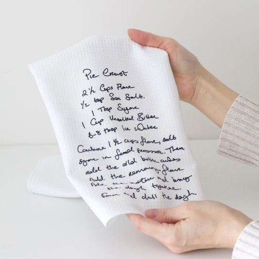 White towel with handwritten recipe held by a person on a light background |Little Heirloom