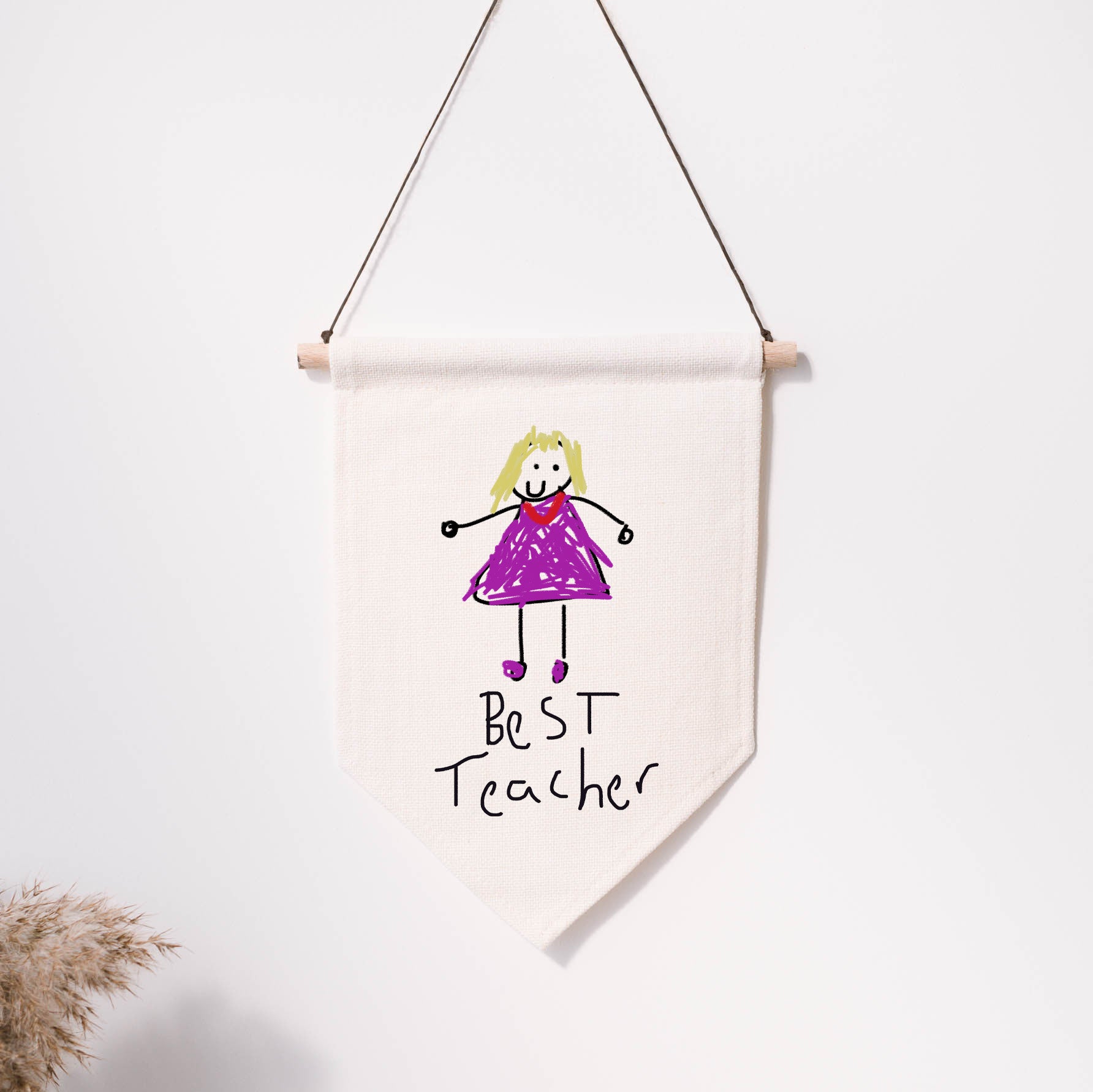 Handmade banner with a drawing of a girl in a purple dress and 'Best Teacher' text, hanging on a white wall. | Little Heirloom