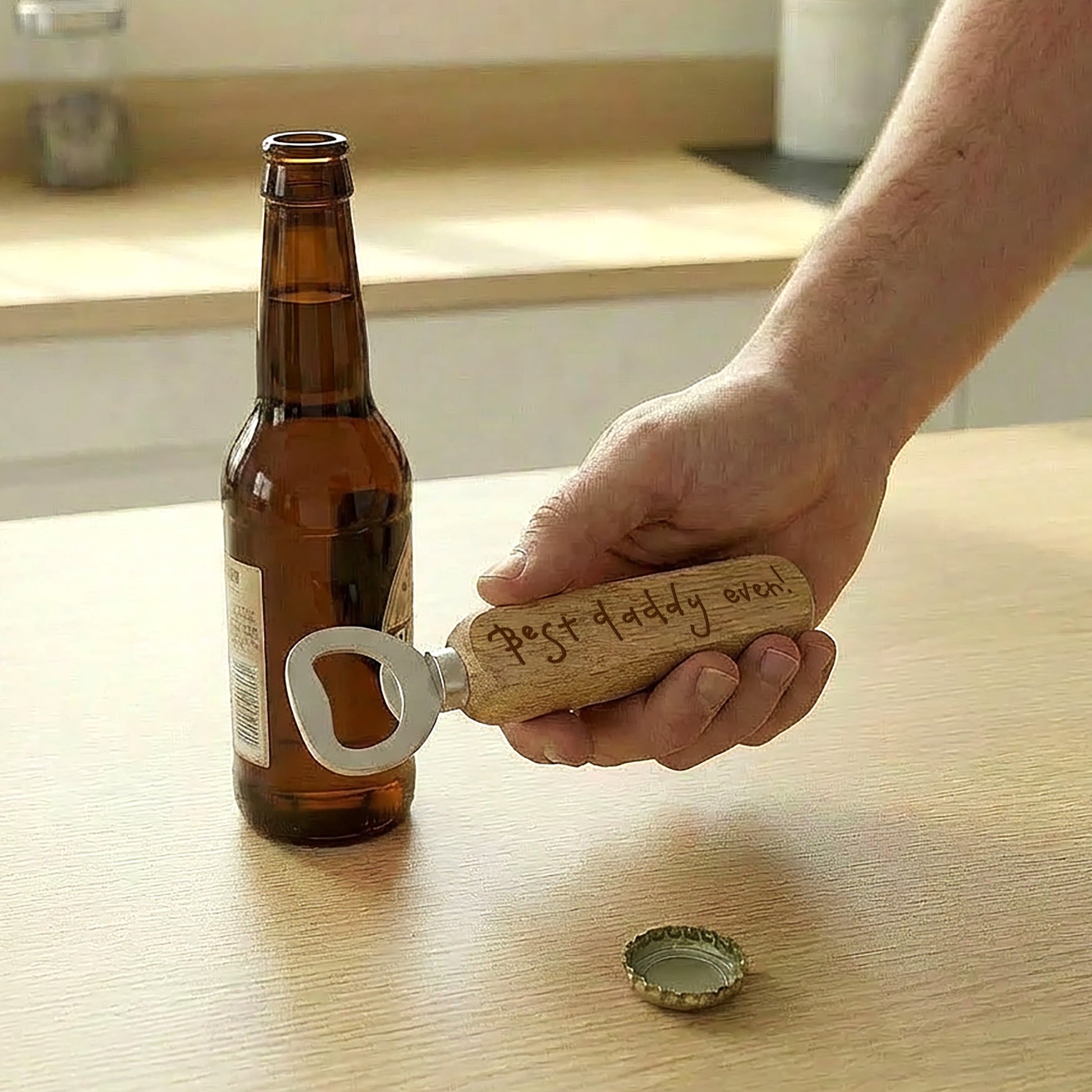 Hand using a bottle opener with 'best daddy ever' written in a child's writing engraved on the handle | Father's Day Gift | Little Heirloom