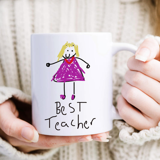Mug with a drawing of a girl in a purple dress and 'Best Teacher' text, held by hands. | Little Heirloom