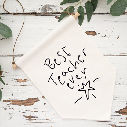 Whiteboard with 'Best Teacher Ever' text on a rustic wooden surface with greenery. | Little Heirloom