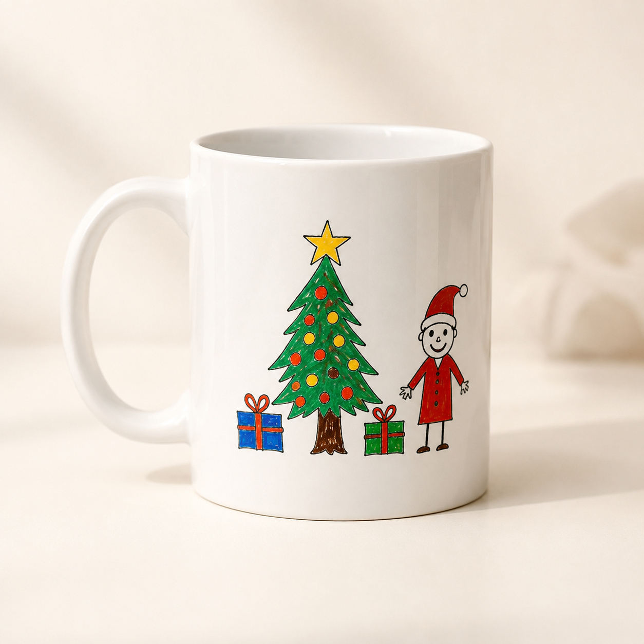 A white ceramic mug with a colourful Christmas-themed illustration featuring a decorated tree, gifts, and a child in a Santa hat | Little Heirloom