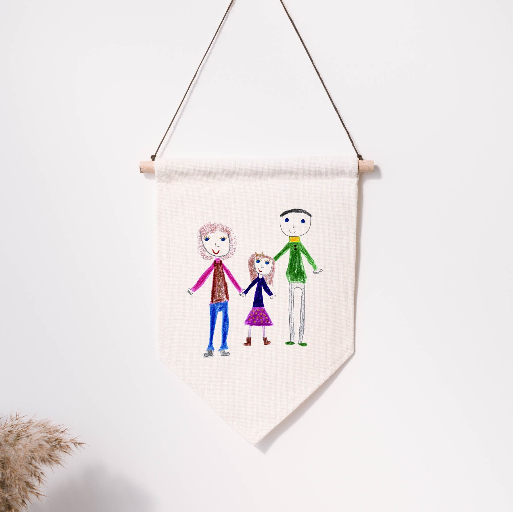 Hand-drawn family portrait on a hanging banner against a white wall. | Little Heirloom
