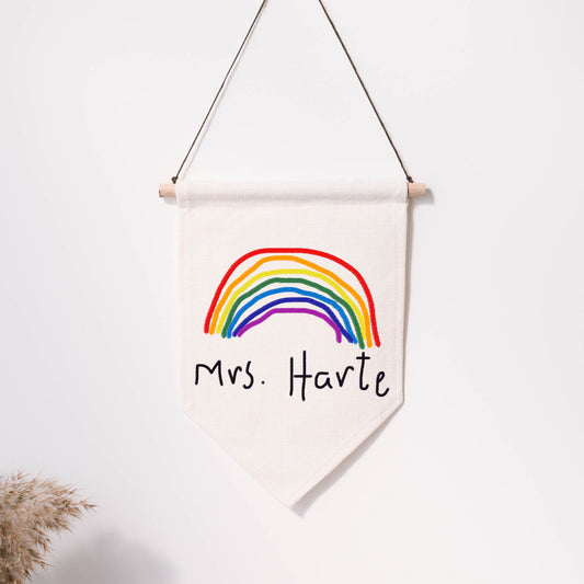Canvas wall hanging with a rainbow and text 'Mrs. Harte' on a white background | Little Heirloom