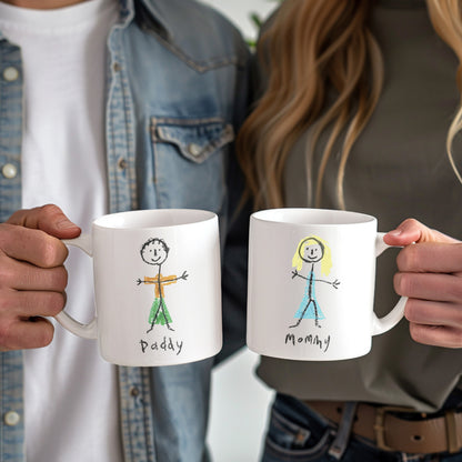 Two people holding mugs with stick figure drawings labeled 'Daddy' and 'Mommy'.  | little heirloom