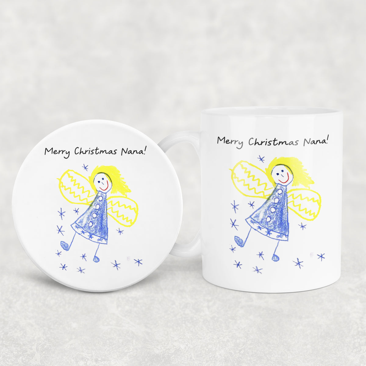 White mug and coaster set with angel illustration and 'Merry Christmas Nana!' text on a light gray background | Little Heirloom