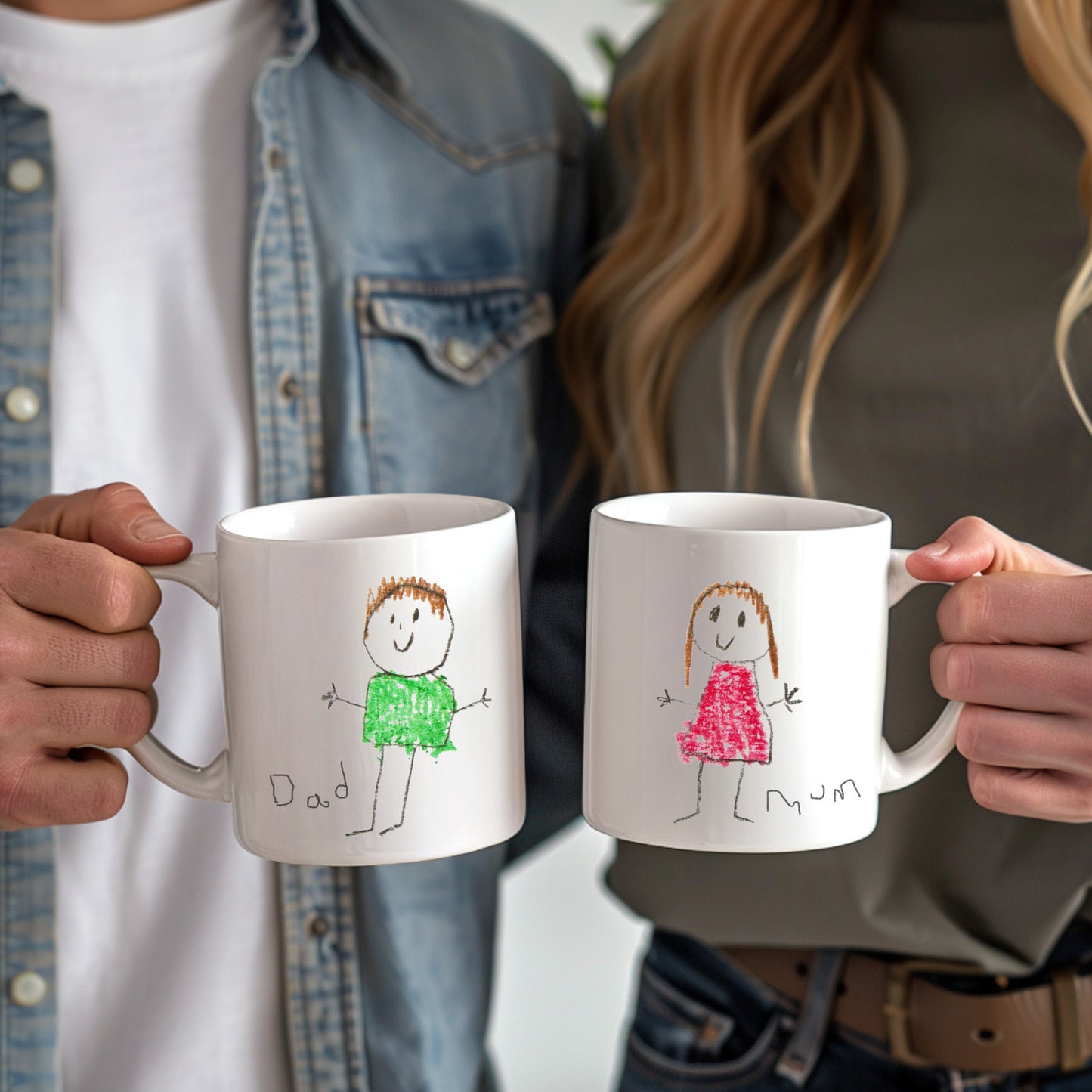 Two people holding mugs with child-like drawings of a father and daughter on a blurred background | little heirloom