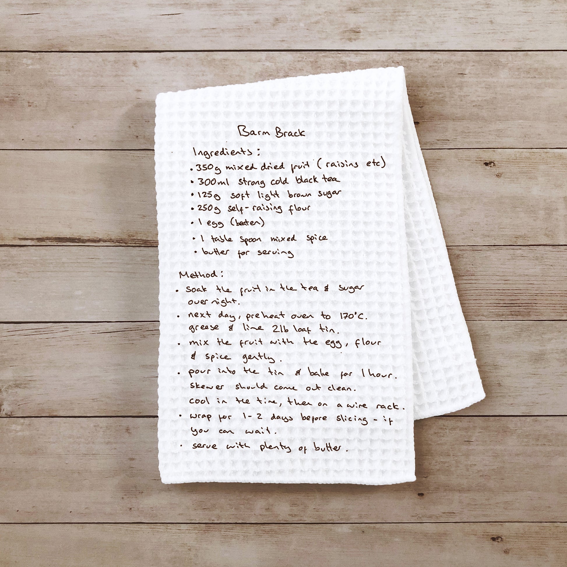 Handwritten recipe for Barn Brack on a white towel over a wooden surface | Gifts for Mother's Day | Little Heirloom